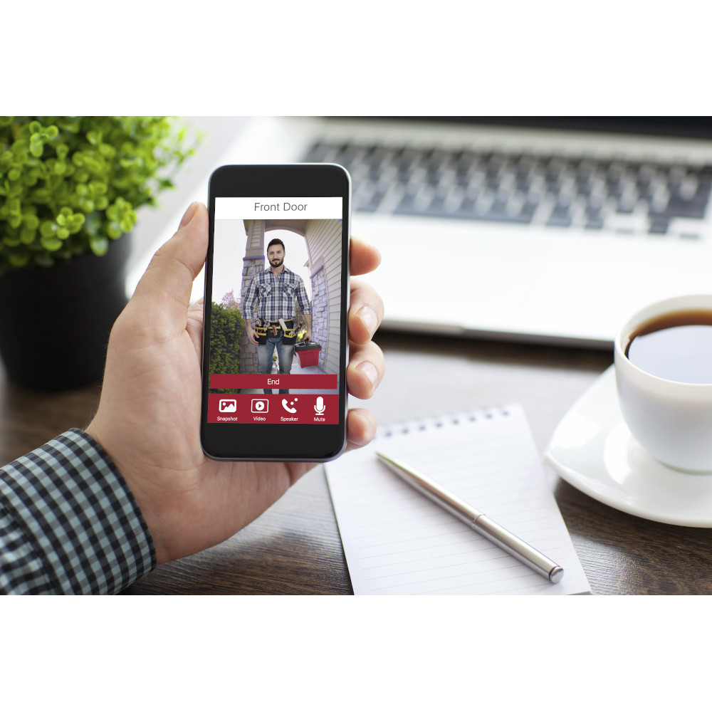 man holding a phone with isolated screen over the desk in the office