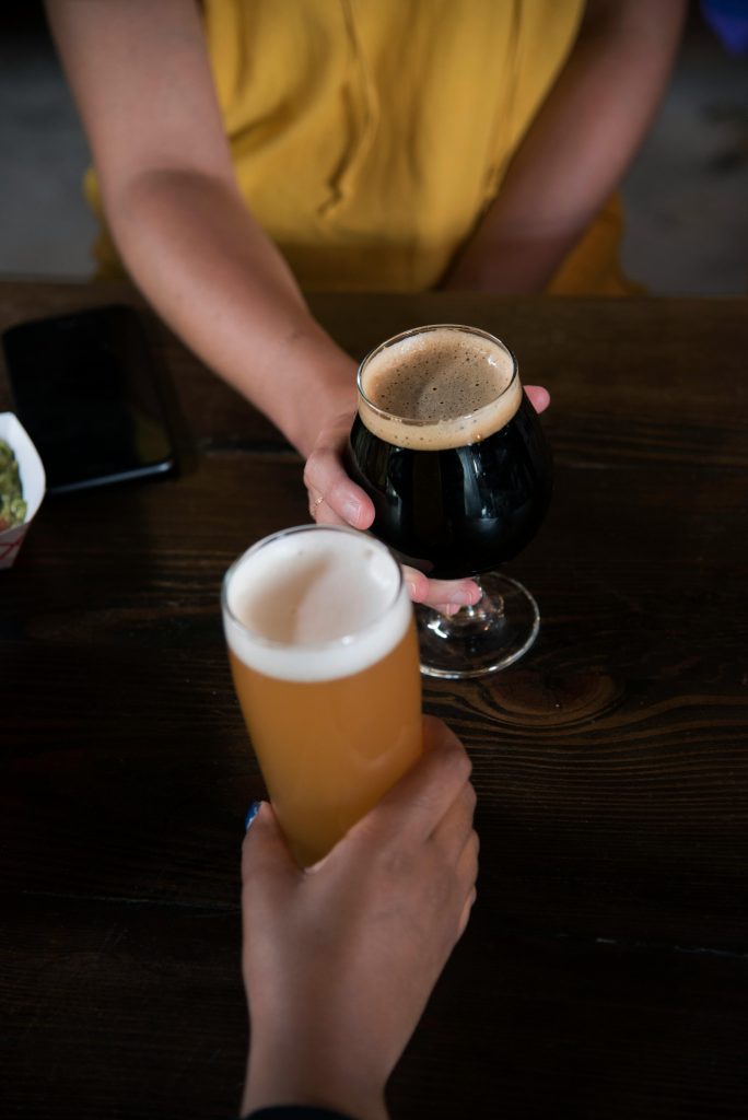 eb horsman showcases two glasses of beer clinging together for German beer Day